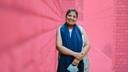 Simran Sethi, a breast cancer patient from India, stands against a wall near the Dilli Haat market in Pitampura in north Delhi.