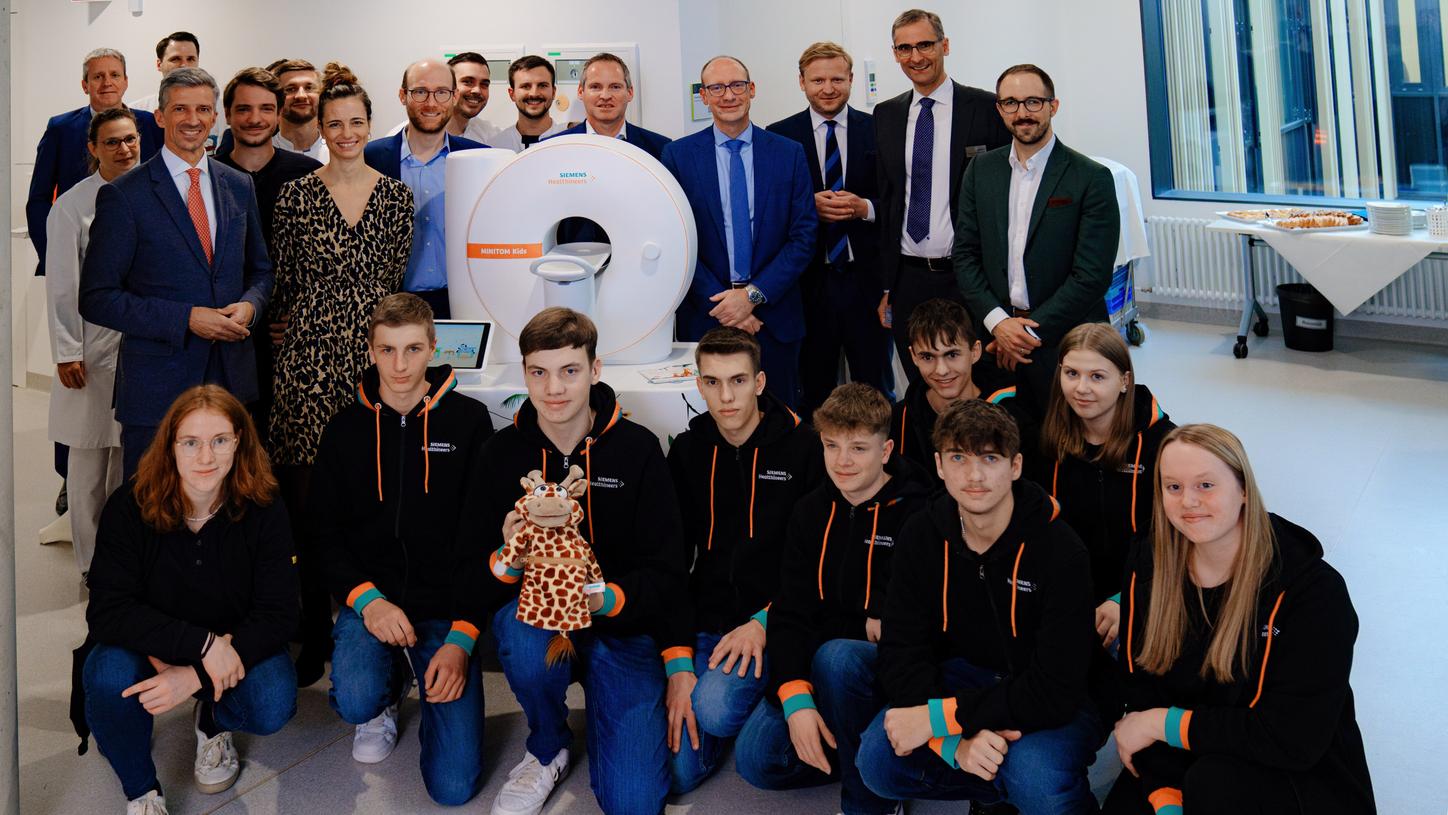 A group of trainees and healthcare professionals in front of a MINITOM Kids.