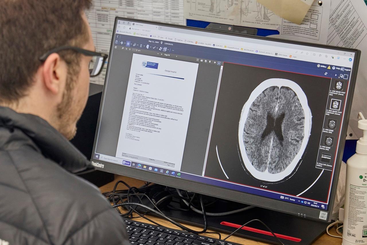 Jonathan Spanos, a medical officer from SA is evaluating a brain scan.