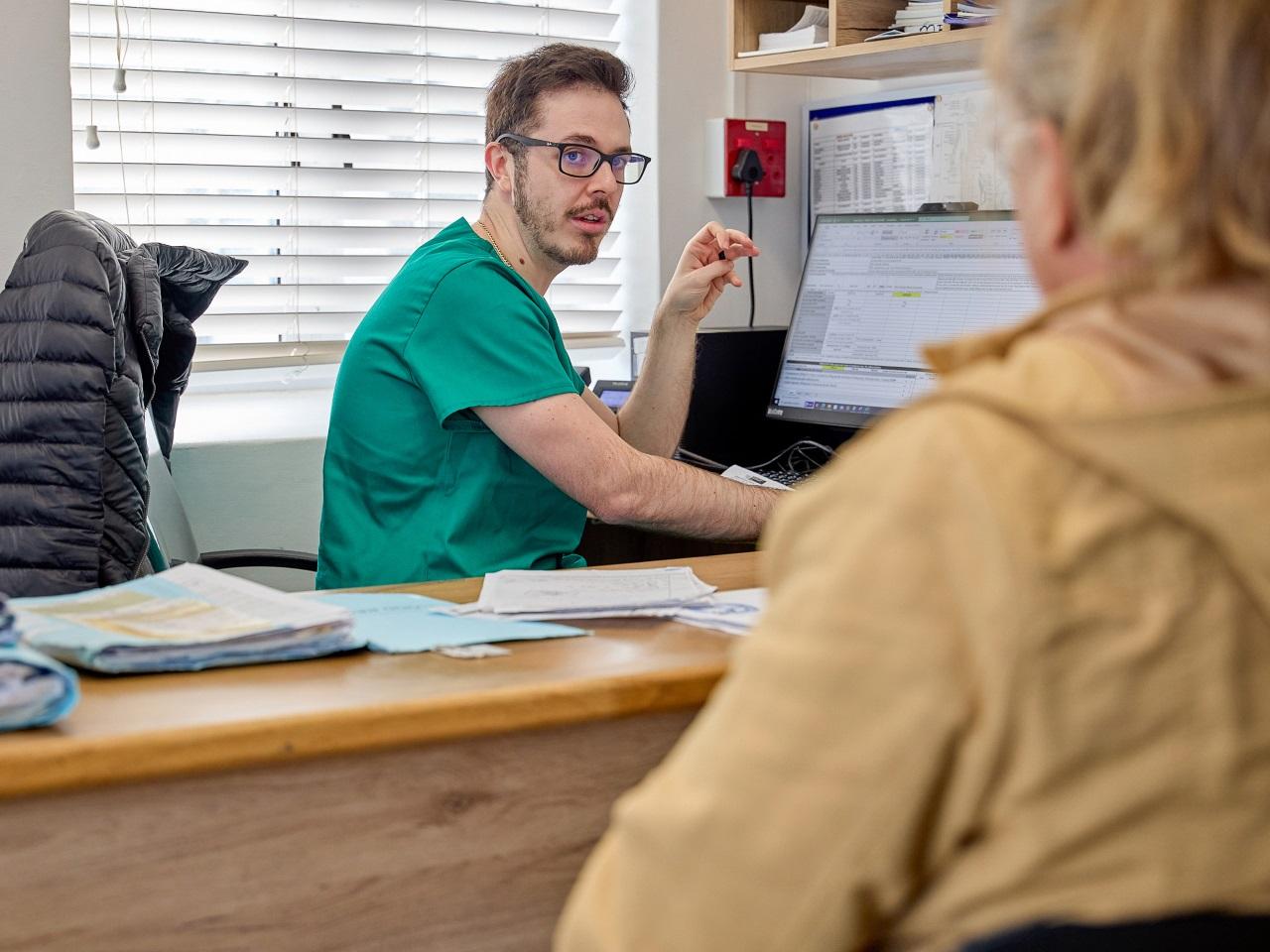 Jonathan Spanos, a medical officer from George in SA is talking to a female patient.