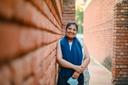Simran Sethi, a breast cancer patient from India, stands against a wall near the Dilli Haat market in Pitampura in north Delhi.