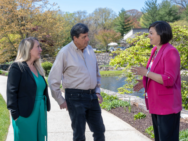 Three colleagues outside on a walk talking